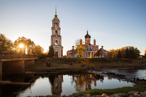 Cathedral of the Resurrection of Christ on the river bank is illuminated by the setting sun. Staraya Russa, Novgorod region, Russia