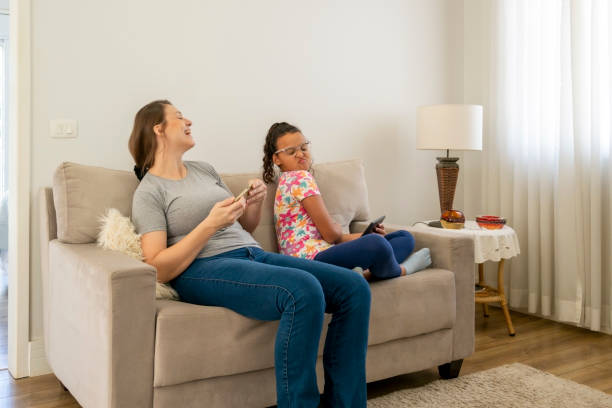 istock Mother and daughter using digital devices at home. 1474151830