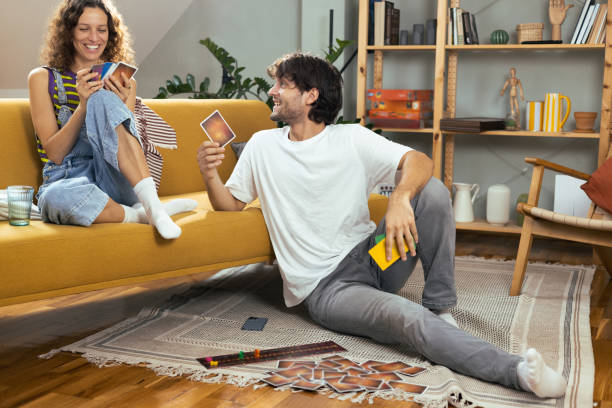 istock Young couple playing a board game at home 1474152066