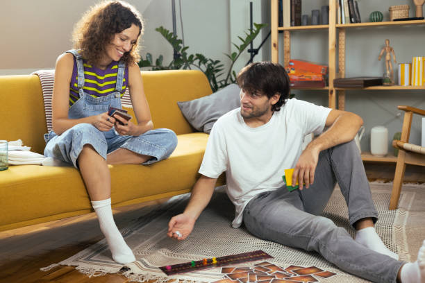 istock Young couple playing a board game and enjoying 1474152074