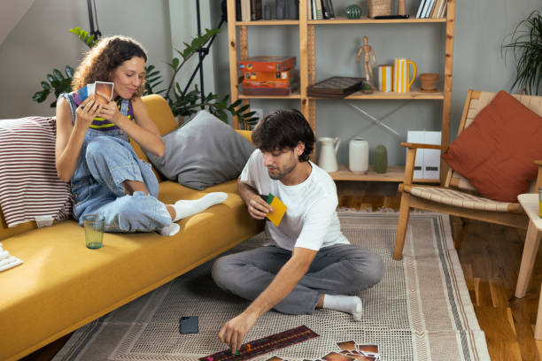 istock Young couple playing a board game and having fun 1474152085