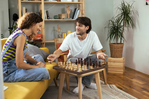 istock Young couple playing chess and enjoying together 1474152105