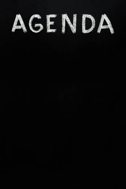istock Black board text agenda template blank agenda design black chalkboard writing blackboard text template black background. Text board blank chalk board written word Agenda background chalkboard texture 1474153054
