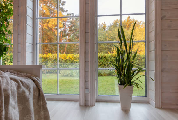 istock Bright photo studio interior with big window, high ceiling, white wooden floor 1474153966
