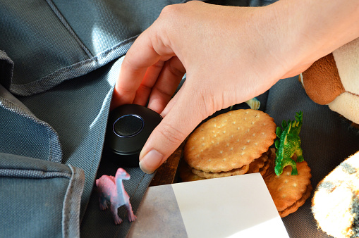 A gps tracker inserted into a child’s schoolbag for real-time tracking.