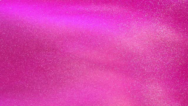 White Glowing Dust Particles Floating in a Pink liquid.
