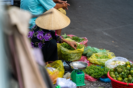 Ho Chi Minh City, Viet Nam 15 October, 2022: Selective focus on Vietnamese buying vegetables, food at Thi Nghe market, Thi Nghe is a local market in northern Vietnam