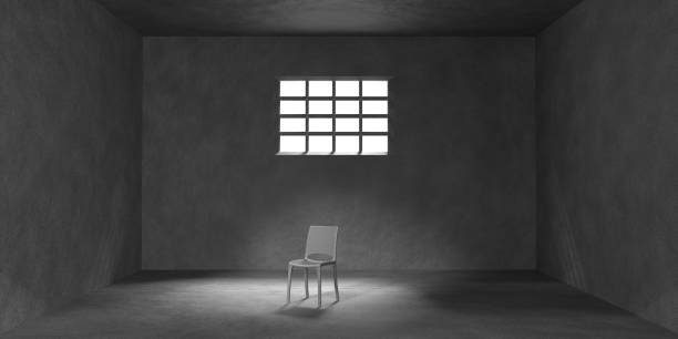 istock Dark prison cell with chair, barred window and sunlight on floor 3d render. Interior empty jail room, cage for criminals and prisoners. Interrogation room or torture chamber concept 1474161694