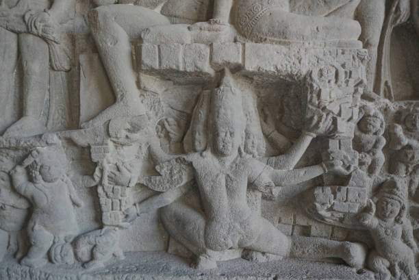 Ellora Caves Interior close up detail of an  orante Stone Sculpture describing the demon king  Ravan trying to lift Lord Shiva and Parvati. stock photo