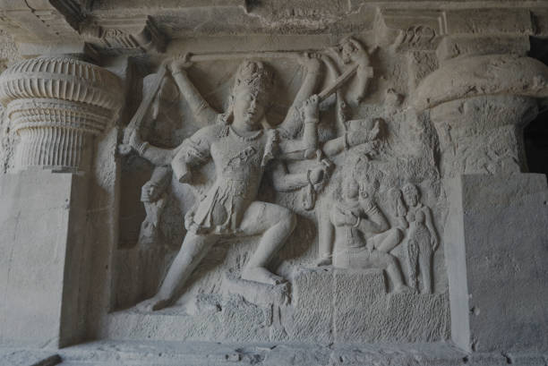 Ellora Caves Interiors Stone Sculpture of the many armed with weapons Goddess Durga slaying the demons stock photo