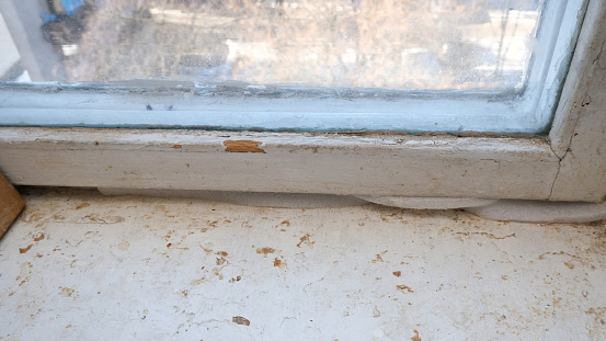 Old, dirty window frame and window sill.