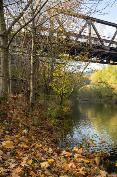 Iron bridge over a river in the autumn nature