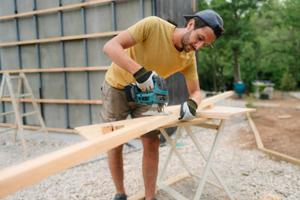 istock Carpenter cutting a wooden plank with a power tool 1474167474