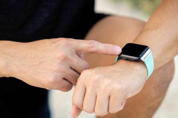 istock Closeup Man hand touching a smart watch. 1474168202