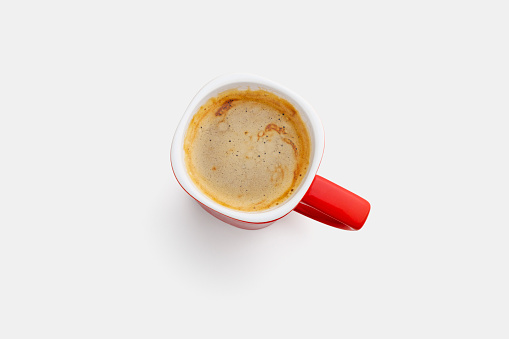 Red cup with coffee and crema isolated on 94% white background. Shot from above. High resolution, preserved highlights.
