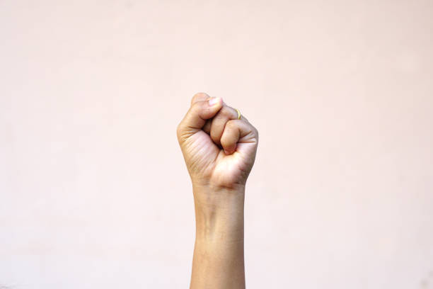 human hand raised fist up top with confidence