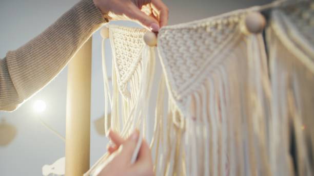 istock Female hands weave mandalas of white strings.( close-up). 1474173764