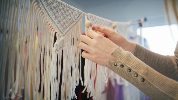 istock Female hands weave mandalas of white strings.( close-up). 1474173798