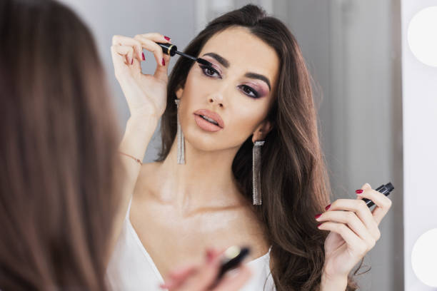 istock Woman Applying Mascara In Front Of Mirror 1474174131