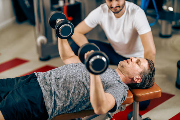 istock Man Doing Workout With Coach In A Gym 1474176541
