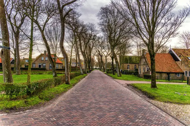 Street with old Dutch commander houses in the town of Ballum on the West-Frisian island Ameland in Autumn