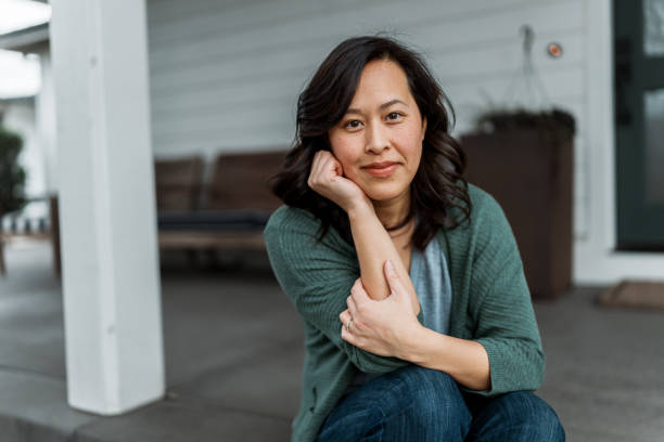 Woman sitting on front step of home
