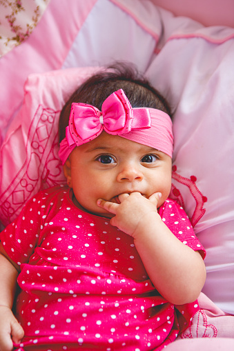 portrait of a baby girl with pink bow on her head