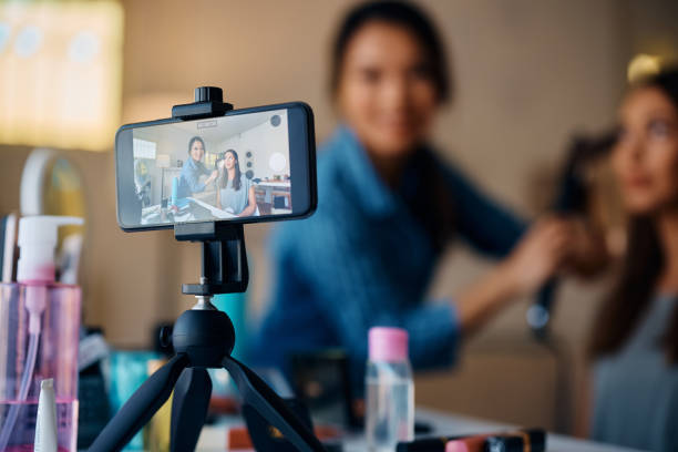 istock Happy female friends recording hairstyle tutorial with smart phone. 1474182725