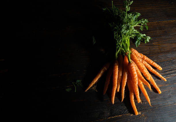 istock Carrots on an antique wooden table 1474183651