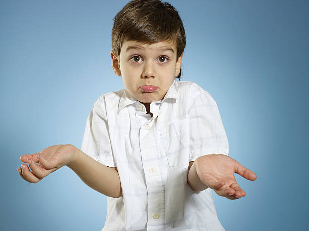 I Have No Idea Little boy shrugs shoulders. careless stock pictures, royalty-free photos & images