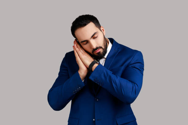 istock Tired bearded man sleeping laying down on her palms, keeping eyes closed, wearing white sweater. 1474185102