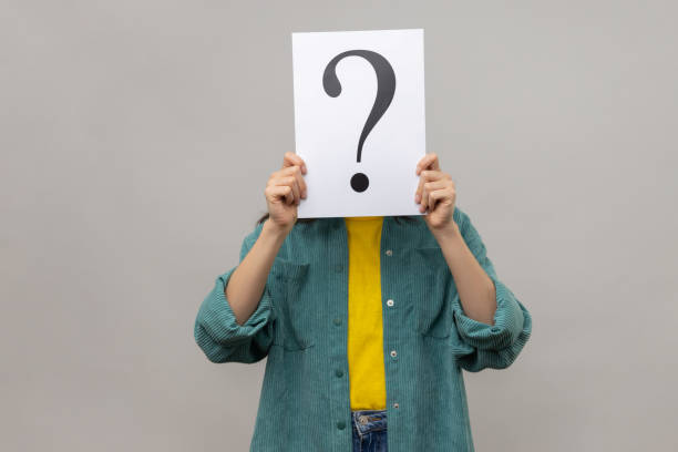 istock Unknown woman covering face with question mark, finding smart solution, asking for advice. 1474185455
