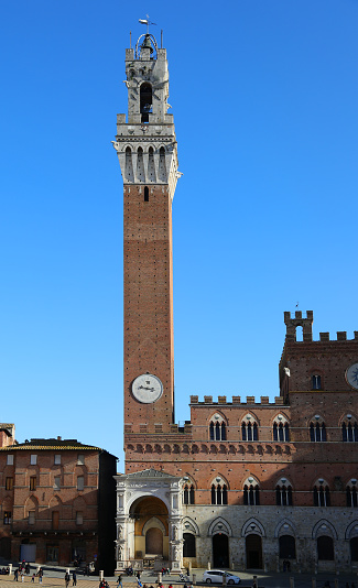 Siena Italy Ancient Tower called TORRE DEL MANGIA and the Cappella a marble tabernacle at the foot of the tower