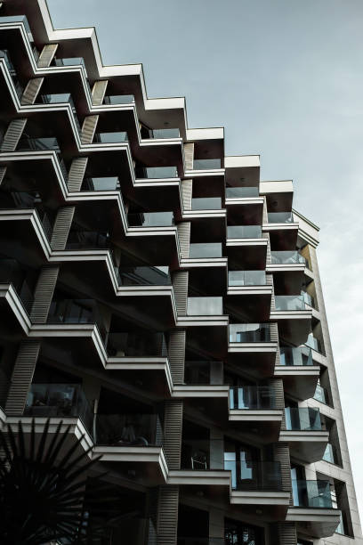 istock Low angle view of facade of building, with triangular balconies with glass railings. 1474188092