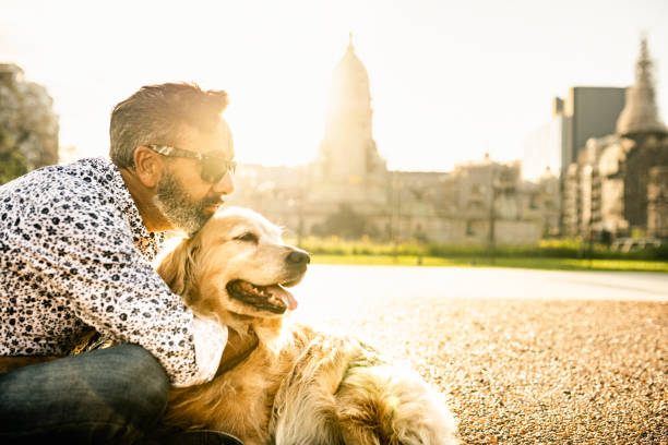 istock Mature man hugs golden retriever 1474189221