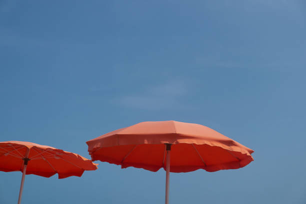 istock two beach umbrellas on the sky 1474190645