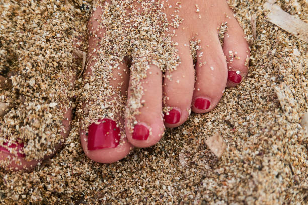 woman’s toes on the beach