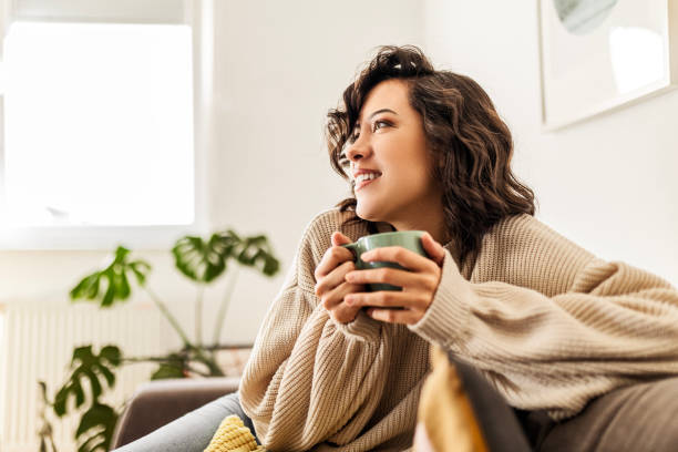 istock Girl relaxing at home drinking coffee 1474192911