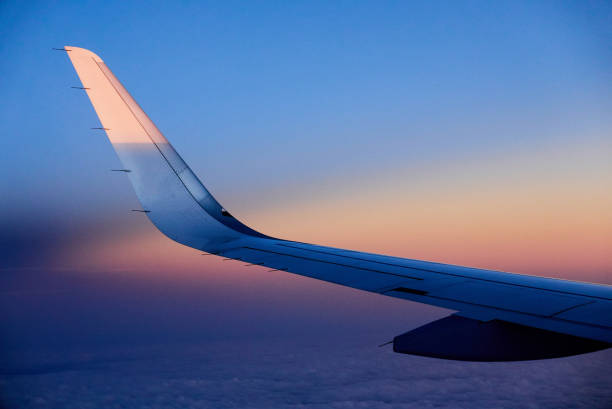 istock wing of a plane in the sky at dawn 1474193919