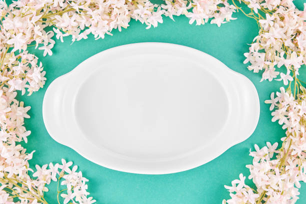 istock Empty Plate On Turquoise Background With Jasmine Flowers 1474194160
