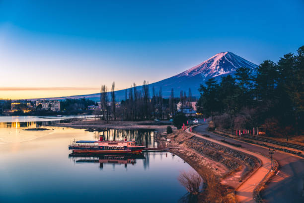 Mount Fuji on a bright winter morning, as seen from across lake Kawaguchi, and the nearby town of Kawaguchiko Mount Fuji on a bright winter morning, as seen from across lake Kawaguchi, and the nearby town of Kawaguchiko Lake Kawaguchi stock pictures, royalty-free photos & images