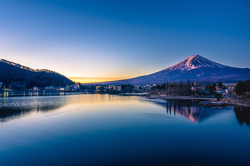 Mount Fuji on a bright winter morning, as seen from across lake Kawaguchi, and the nearby town of Kawaguchiko