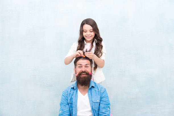 Daughter style, you smile. Little daughter stylist. Small daughter hairstyle fathers hair. Happy family. Cute hairdresser. Daughter barber did me first. Hair salon. Barbershop Daughter style, you smile. Little daughter stylist. Small daughter hairstyle fathers hair. Happy family. Cute hairdresser. Daughter barber did me first. Hair salon. Barbershop. fashionable dad stock pictures, royalty-free photos & images