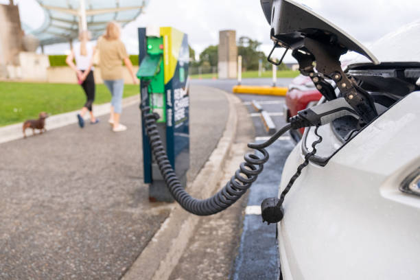 istock Women Walking Dog While Charging EV 1474198097