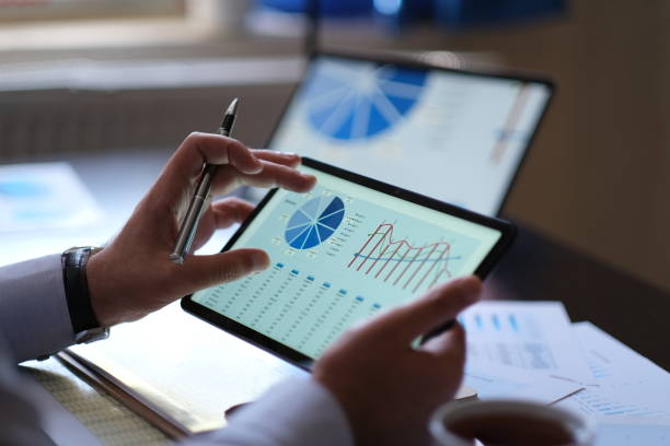 istock Businessman is analyzing business performance and data from digital tablet screen 1474198253