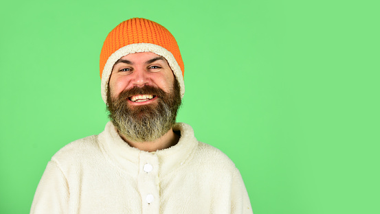 Lets celebrate. cold and flu. Portrait of brutal man in fleece sweatshirt. Handsome male model wearing warm hat. casual man in winter hat and warm clothes. happy hipster wear warm hat. copy space.