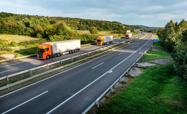 istock Trucks with containers on highway 1474199808