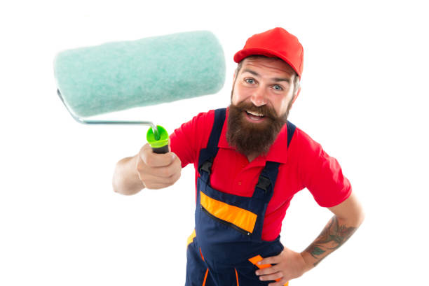 istock positive man painter with paintroller isolated on white background. man painter with paintroller 1474200669