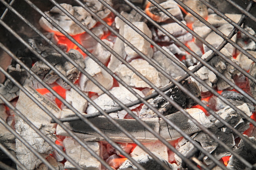 a charcoal grill with glowing coals