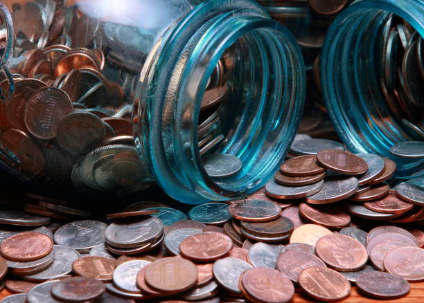 istock Coins in a blue canning jar 1474205529